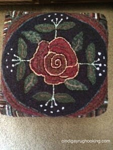 Rose Scroll footstool hooked by Pat Cassidy, designed by Cindi Gay