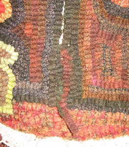 Seam in a rug hooked footstool