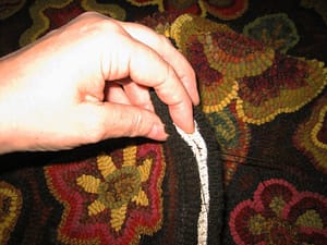 Sewing the side seams on a rug hooked footstool