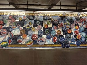 tile art of marbles on NYC subway wall