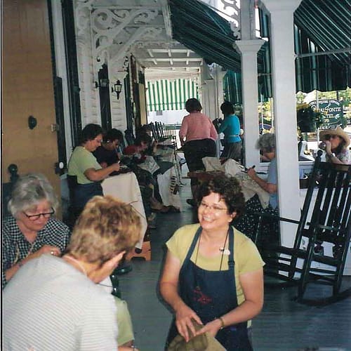 Cindi Gay teaching on the porch at Cape May NJ rug hooking camp