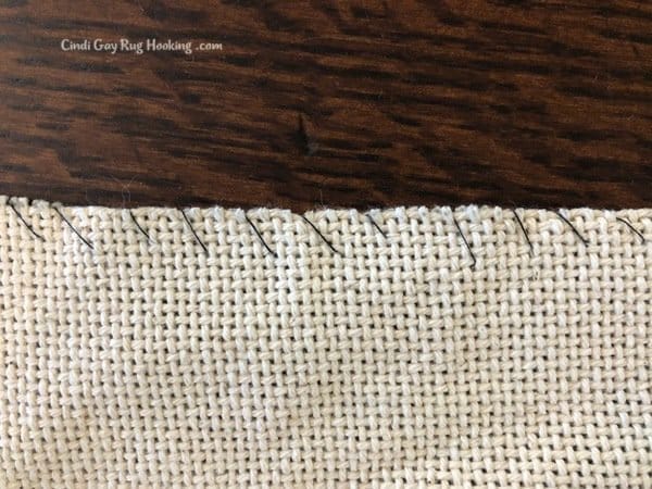 closeup of simple whip stitch to prevent fraying