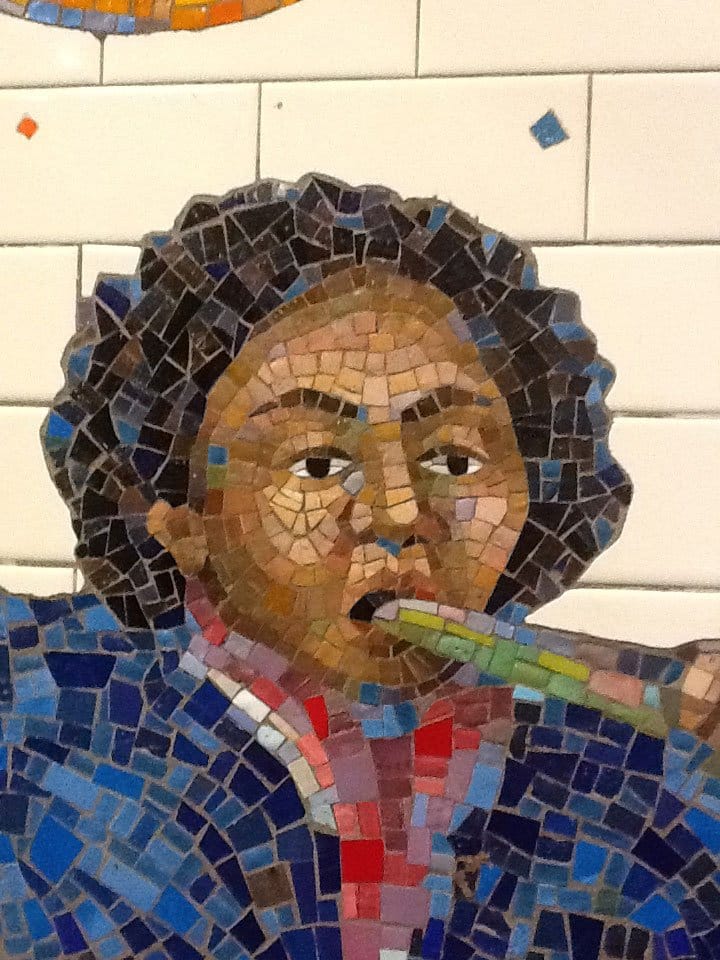 Tile art NYC subway boy playing instrument