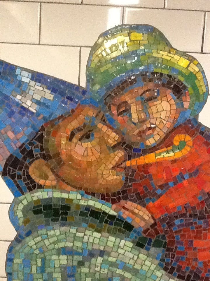Tile art NYC subway closeup of man holding child